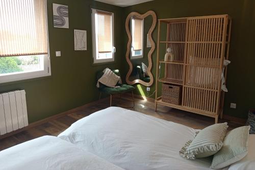 a bedroom with a white bed and a mirror at New apartment with terrace in the center in Stella-Plage