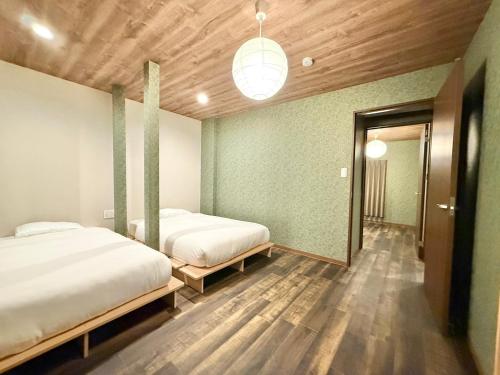 Ένα ή περισσότερα κρεβάτια σε δωμάτιο στο Hotel Kototoi Juku HAKU