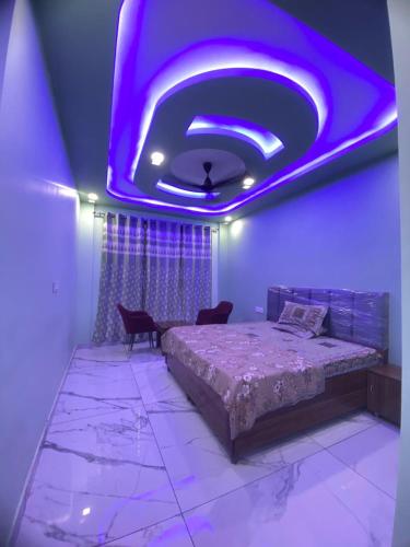a bedroom with a bed and a purple ceiling at Revanta Home Stay in Anandpur Sāhib