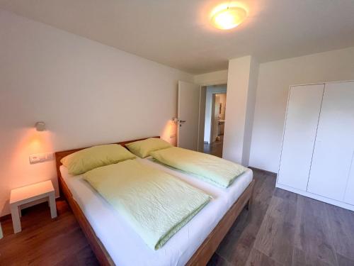 a bedroom with a large bed with yellow pillows at Apartment Benjamin by Interhome in Hollersbach im Pinzgau