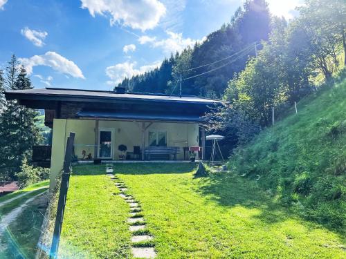 a house on a hill with a grass yard at Apartment Benjamin by Interhome in Hollersbach im Pinzgau