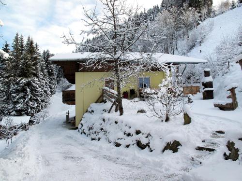 a house covered in snow in front at Apartment Benjamin by Interhome in Hollersbach im Pinzgau