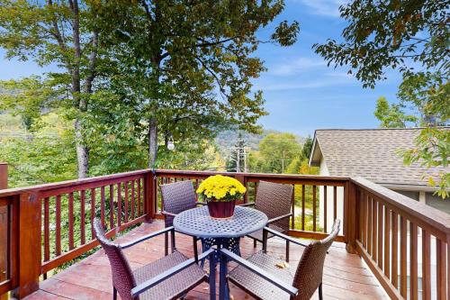 a patio with a table and chairs on a deck at Bear's Loft in Beech Mountain