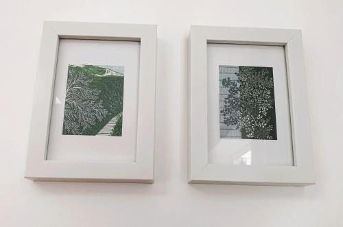 two white frames hanging on a wall at Garden room with parking in Lewes