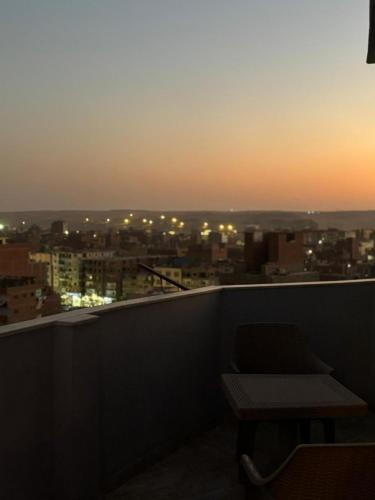a balcony with a table and a view of a city at Abdin pyramids view in Cairo