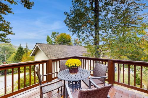a patio table with two chairs on a deck at Bear's Loft in Beech Mountain