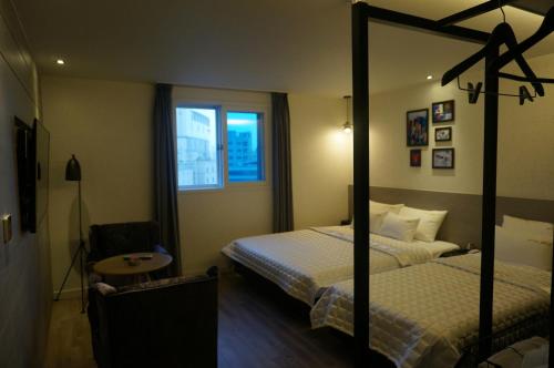 Postel nebo postele na pokoji v ubytování MU Hotel