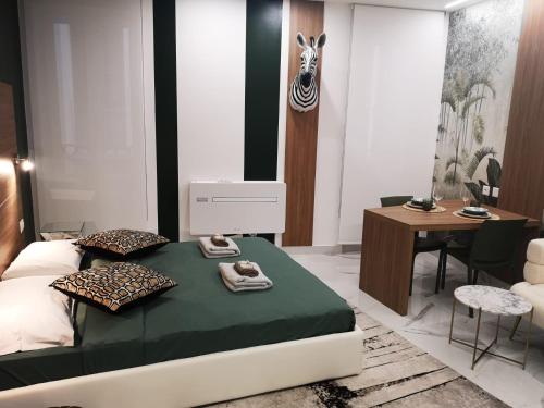 a bedroom with a bed and a table and a desk at TALEDA Apartments - Modern Apartments & Self Checkin in the Old Town in Lugano
