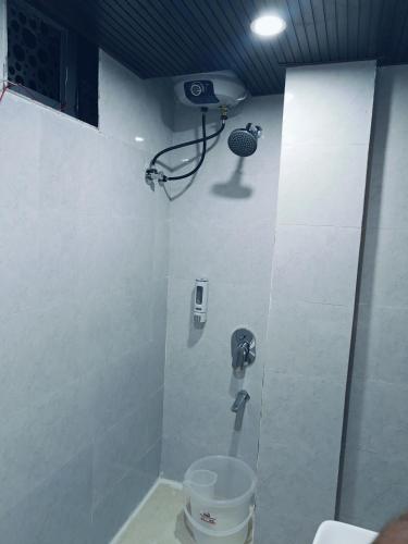 a bathroom with a toilet and a camera on the wall at Hotel jmm s14 in Udaipur