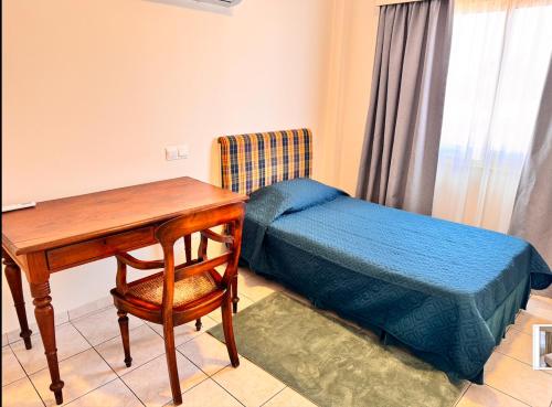 a bedroom with a desk and a bed and a table at 3 bedroom house fully renovated in Limassol