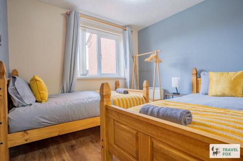 a bedroom with two beds and a window at Ann's Home Near Alton Towers in Rocester