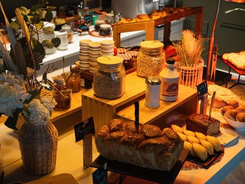 a table with many different types of bread and other foods at Novotel Lille Centre Gares in Lille