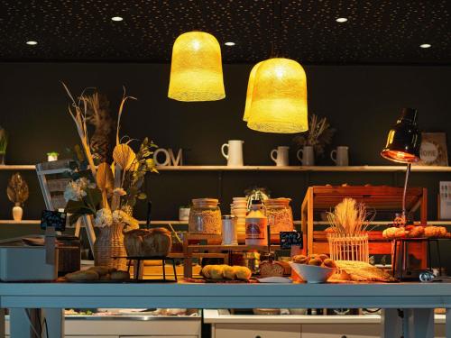a store with two lights above a table with food at Novotel Lille Centre Gares in Lille