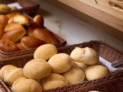 a bunch of baskets filled with bread and buns at Novotel Ieper Centrum in Ypres