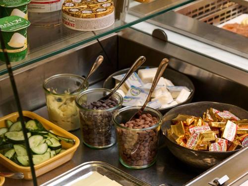 a group of containers of food sitting on a counter at Novotel Ieper Centrum in Ypres