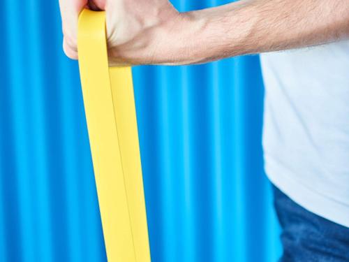 a man holding a yellow paper in his hand at ibis budget Zurich City West in Zürich