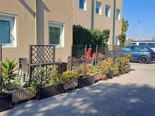 a row of plants in front of a building at Ibis Hotel Alicante in Alicante
