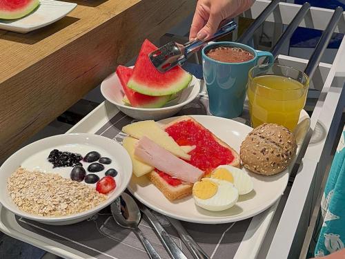 a table with two plates of breakfast food on it at Ibis Budget Madrid Alcorcón Móstoles in Alcorcón