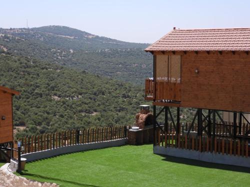a balcony of a building with a view of a mountain at اكواخ القلعه in Ajloun