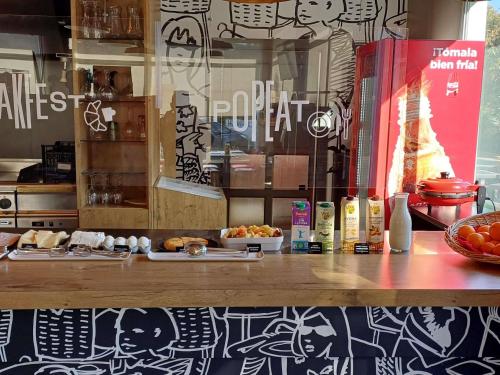 a counter in a restaurant with food on it at Ibis Hotel Alicante in Alicante
