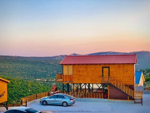 a building with a car parked in front of it at اكواخ القلعه in Ajloun