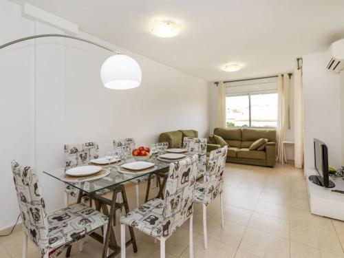 a dining room and living room with a table and chairs at Apartment República Dominicana by Interhome in Miami Platja