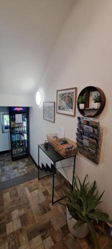 a room with a table and a mirror on the wall at VilaVala in Nymburk