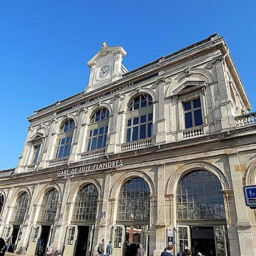 a large building with a clock tower on top of it at Meublé atypique chez particulier in La Madeleine