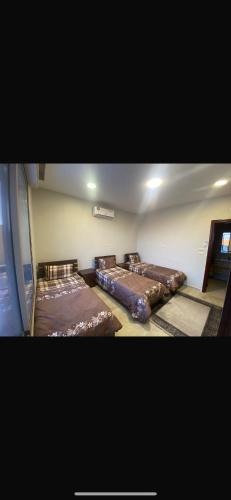 two beds sitting in a room with at Moon farm in Amman