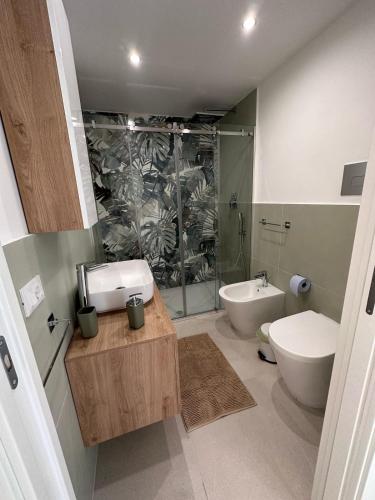 a bathroom with a sink and a toilet and a tub at Lo duca luxury home in Cefalù