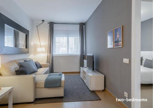 a living room with a couch and a television at Inside Barcelona Apartments Salva in Barcelona