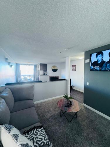 a living room with a couch and a flat screen tv at Amazing Universal Studios Loft FREE parking in Los Angeles