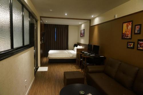 Postel nebo postele na pokoji v ubytování MU Hotel