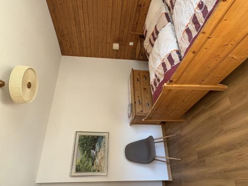 a bedroom with a quilt hanging on the wall at Apartment Haus Salü 5 by Interhome in Saas-Fee