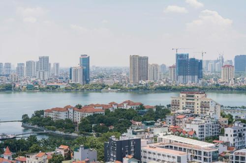 a view of a city with a river and buildings at D’Leroi Soleil - Westlake Suite & Apartment in Hanoi