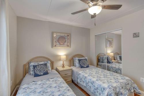 a bedroom with two beds and a ceiling fan at Beach Dont My Vibe in Ormond Beach