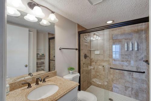 a bathroom with a shower and a sink and a toilet at Beach Dont My Vibe in Ormond Beach