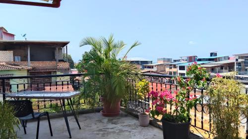 a balcony with plants and a table and chairs at Alojamiento Familiar Custodia in Tarapoto