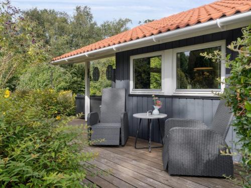 a deck with chairs and a table on a house at Holiday Home Emelita - 175m from the sea by Interhome in Ågerup