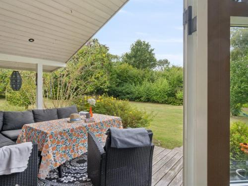 a patio with a table and chairs on a porch at Holiday Home Emelita - 175m from the sea by Interhome in Ågerup