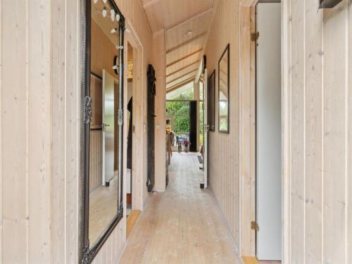 a hallway of a house with wooden floors and windows at Holiday Home Emelita - 175m from the sea by Interhome in Ågerup