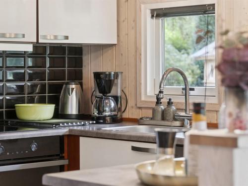 a kitchen with a sink and a stove top oven at Holiday Home Emelita - 175m from the sea by Interhome in Ågerup