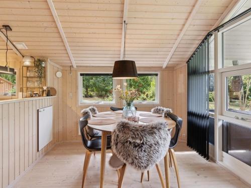 a kitchen and dining room with a table and chairs at Holiday Home Emelita - 175m from the sea by Interhome in Ågerup