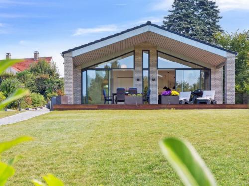 a house with a conservatory with a lawn at Holiday Home Troels - 945m from the sea by Interhome in Hornbæk