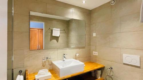 a bathroom with a white sink and a mirror at Alpenblick in Klosters