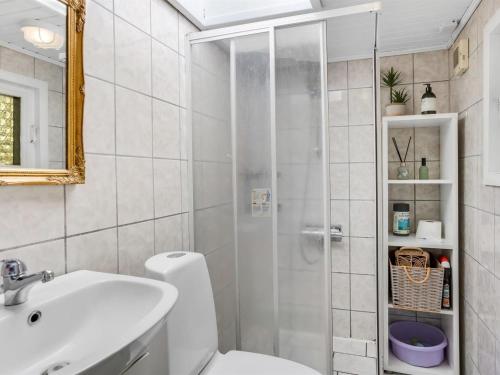 a bathroom with a shower and a toilet and a sink at Holiday Home Adia - 500m from the sea by Interhome in Hejlsminde