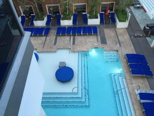 an overhead view of a pool with blue chairs at Vegas High Rise Condo w 2 Balconies w Resort in Las Vegas