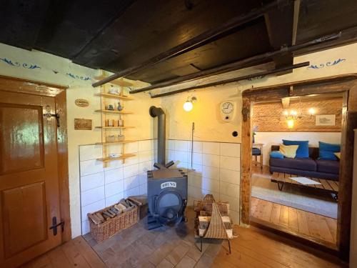 a living room with a wood stove in a room at Chalet Schipplbadstube by Interhome in Annaberg im Lammertal