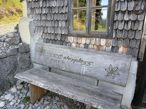 a wooden bench sitting in front of a building at Chalet Schipplbadstube by Interhome in Annaberg im Lammertal