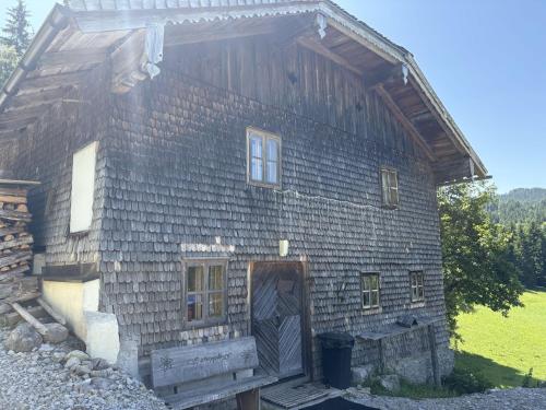 a wooden barn with a door in the side of it at Chalet Schipplbadstube by Interhome in Annaberg im Lammertal